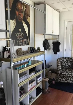 A hair salon with a leopard print chair and shelves.