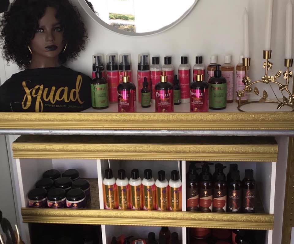 A shelf full of hair products and a mirror.