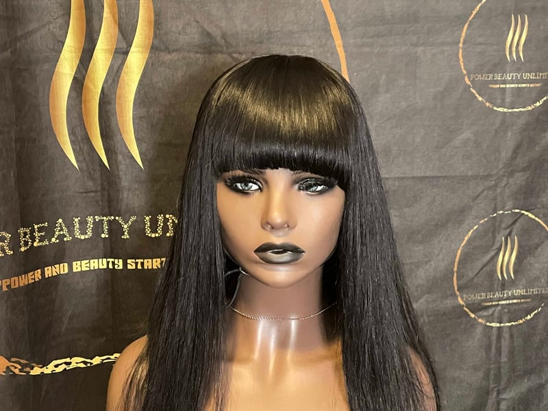 A mannequin wig with bangs and black hair.